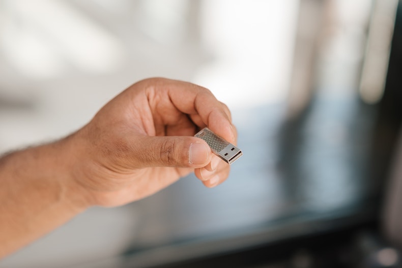 white man holding a usb in his hand