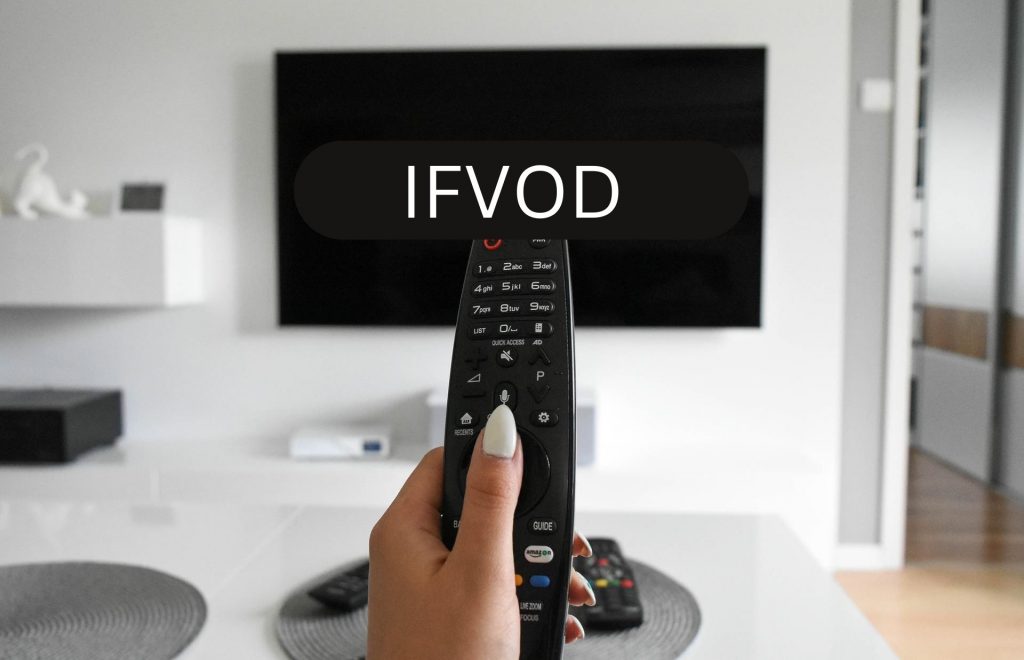 A woman hand controlling TV with a TV remote and TV is showing IFVOD