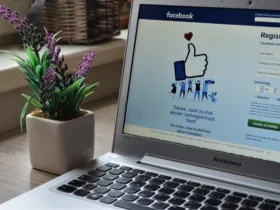 A computer with a thumbs up on the screen Description automatically generated