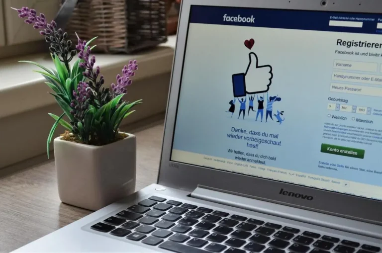 A computer with a thumbs up on the screen Description automatically generated